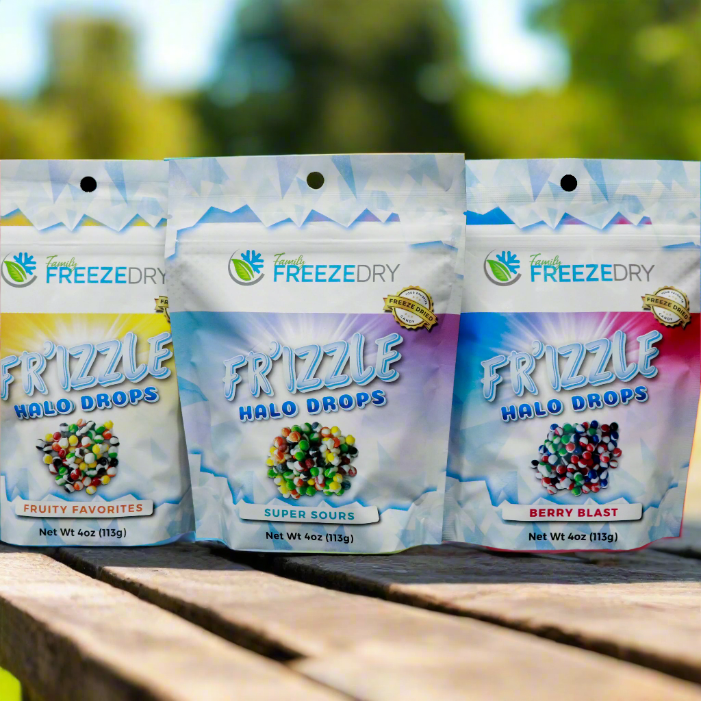 Halo Drops freeze dried Skittles in a group photo outdoors. Flavors include Original, Sours, and berry